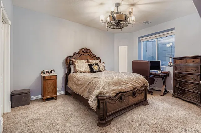 a bedroom with a bed and a chandelier