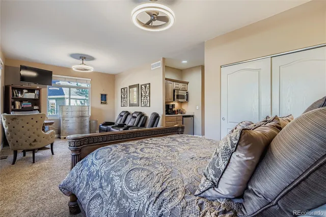 a bed room with a bed couch and a window