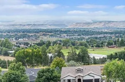 an aerial view of residential houses with outdoor space and trees