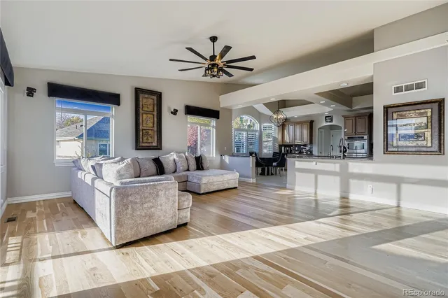 a living room with furniture and a wooden floor