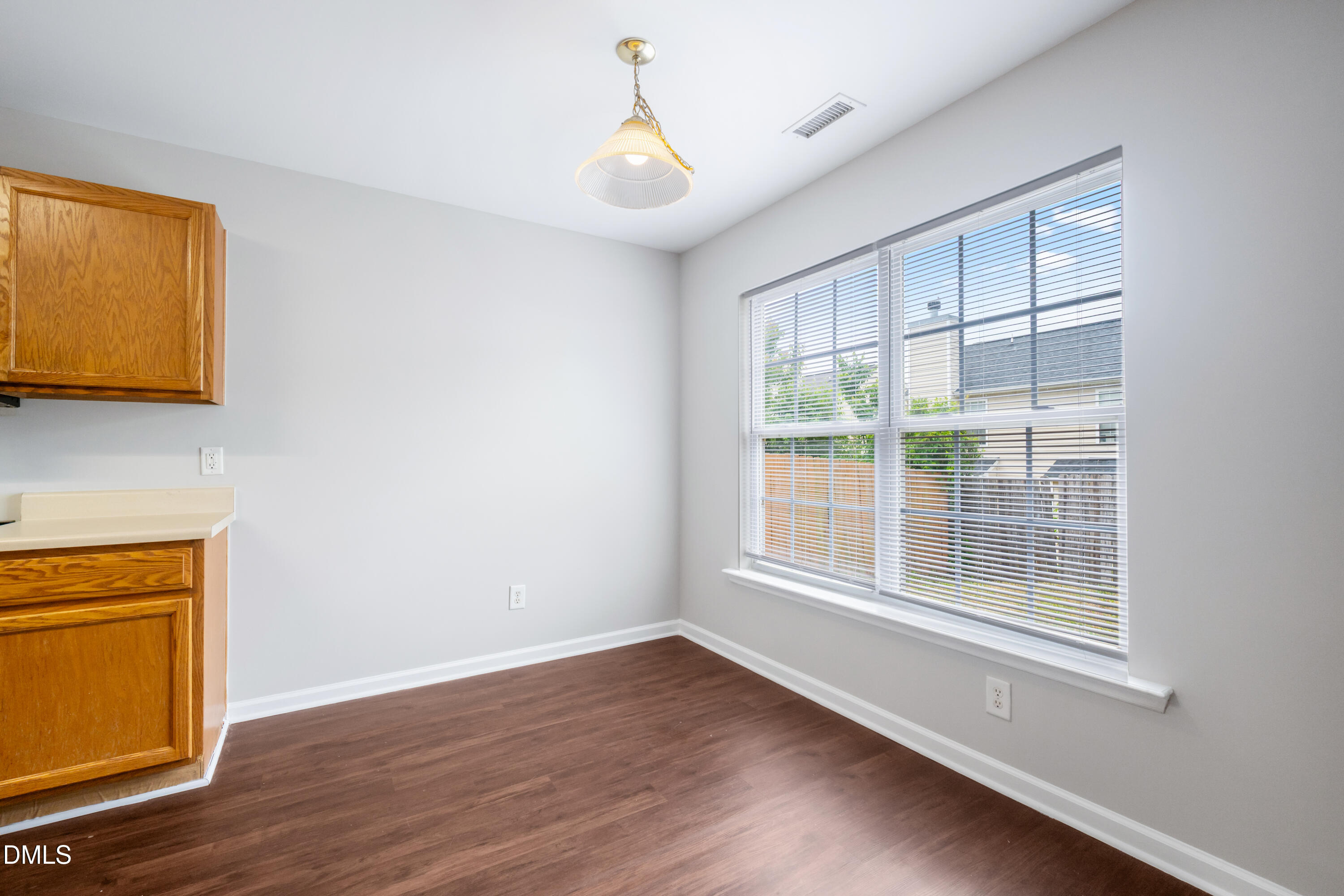 1532 Pebble Ridge Drive Raleigh, NC 27610 - Photo 20 of 40 a view of an empty room with a window and wooden floor