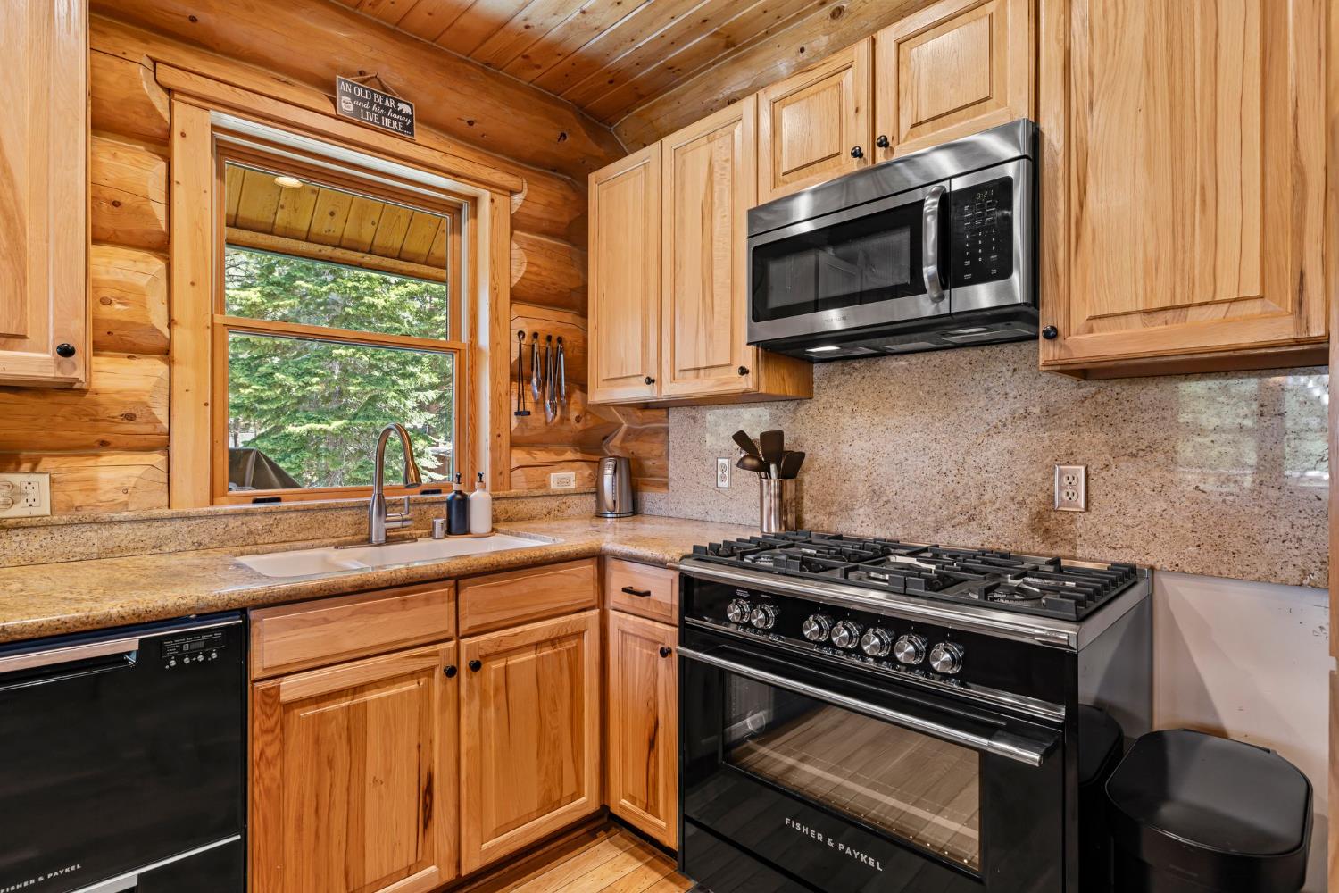 3589 Rocky Point Road South Lake Tahoe, CA 96150 - Photo 13 of 95 a kitchen with stainless steel appliances a stove a sink and a microwave
