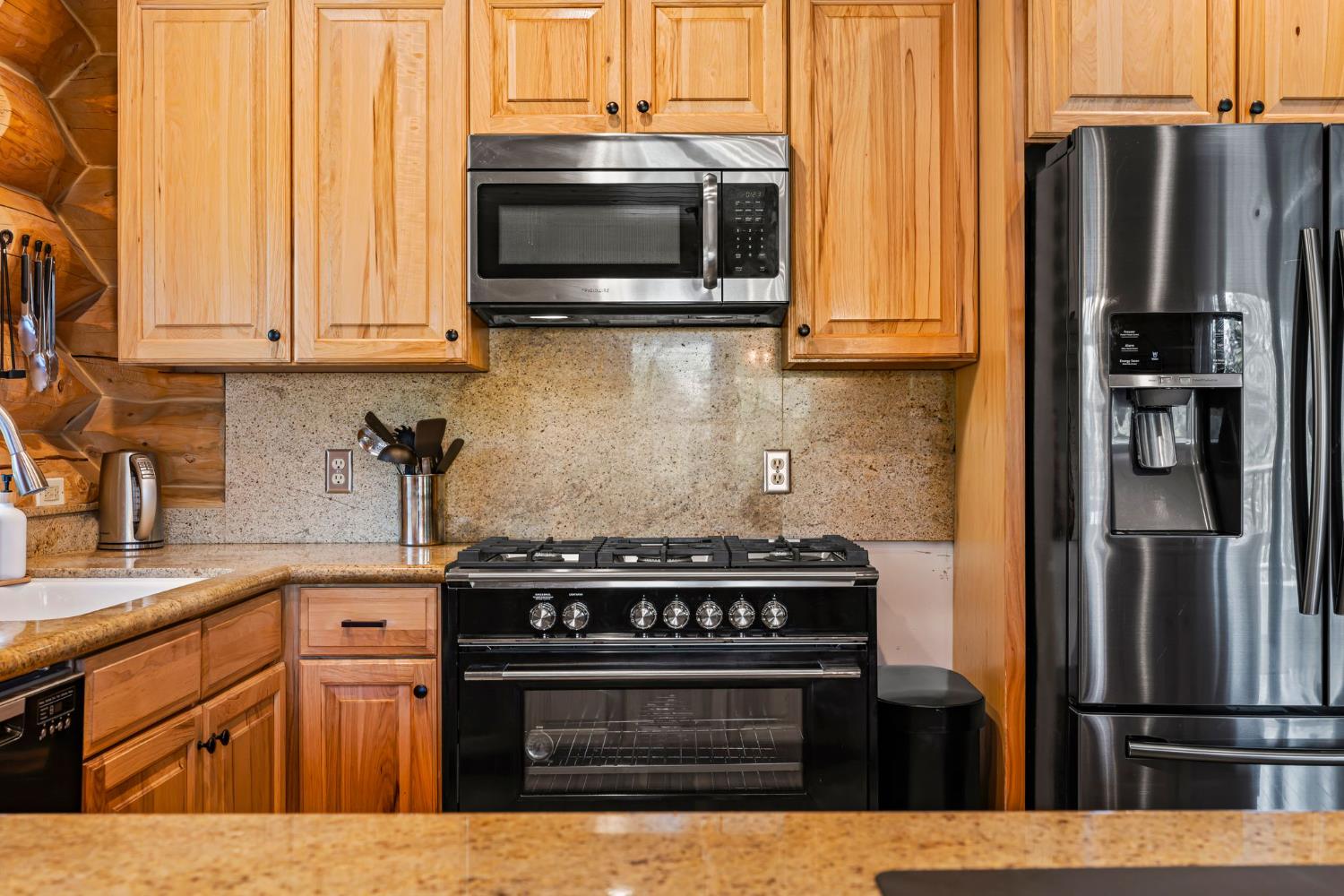 3589 Rocky Point Road South Lake Tahoe, CA 96150 - Photo 14 of 95 a kitchen with stainless steel appliances granite countertop a stove microwave refrigerator and sink
