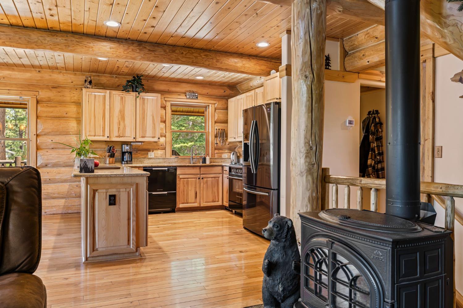 3589 Rocky Point Road South Lake Tahoe, CA 96150 - Photo 17 of 95 a kitchen with stainless steel appliances a refrigerator a sink a stove and white cabinets with wooden floor