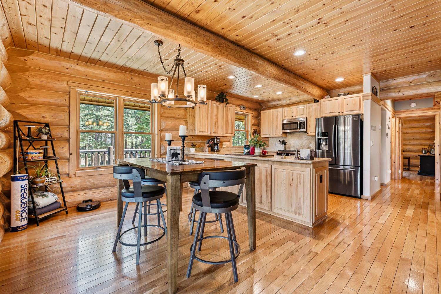 3589 Rocky Point Road South Lake Tahoe, CA 96150 - Photo 6 of 95 a kitchen with stainless steel appliances kitchen island granite countertop wooden floors and wooden cabinets