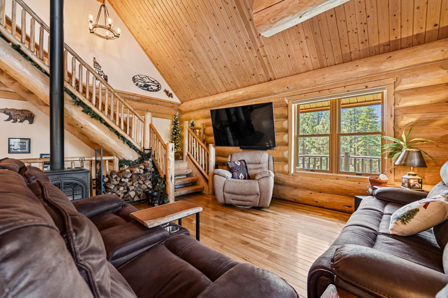 3589 Rocky Point Road South Lake Tahoe, CA 96150 - Photo 7 of 95 a living room with furniture a flat screen tv and a floor to ceiling window
