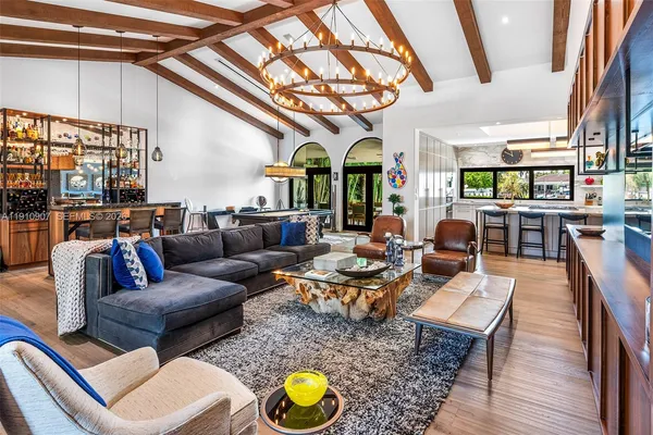 a living room with furniture a rug and a chandelier