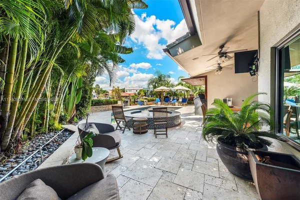 a view of a patio with dining table and chairs potted plants