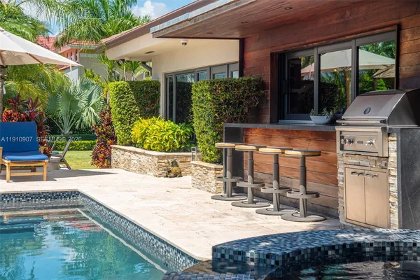 a view of a house with backyard and sitting area