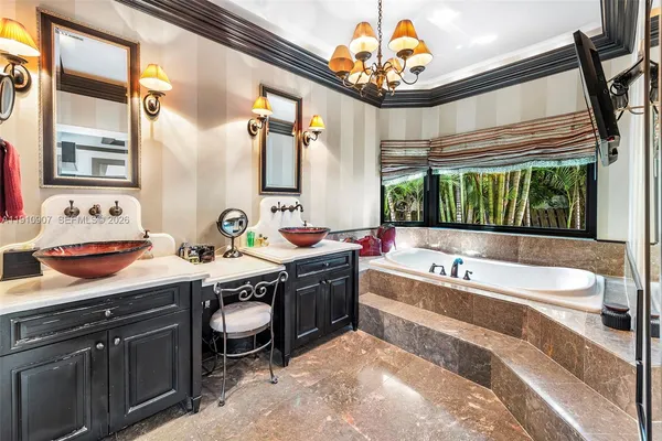 a spacious bathroom with a tub sink and a large mirror