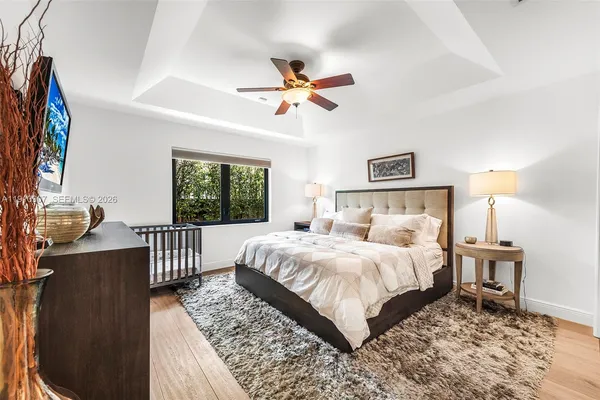 a bedroom with a large bed and a window