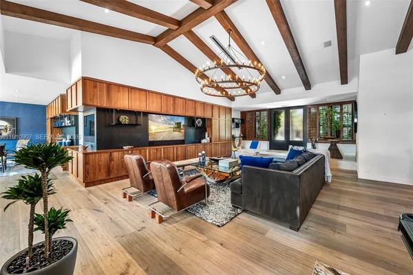 a living room with furniture a couch and a potted plant