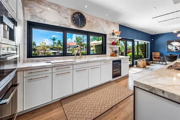 a large kitchen with stainless steel appliances kitchen island granite countertop a stove and cabinets