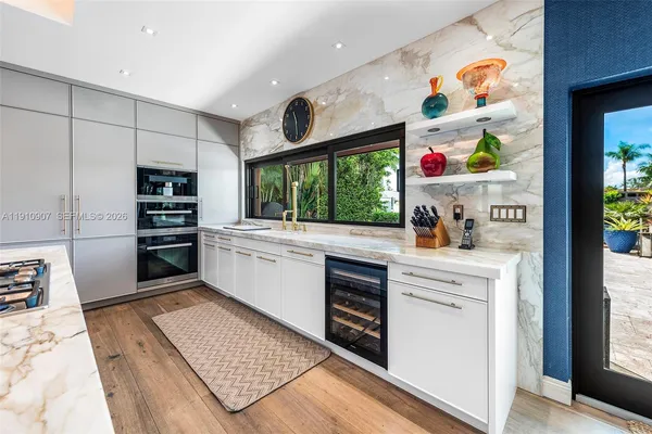 a kitchen with stainless steel appliances a refrigerator and a stove top oven
