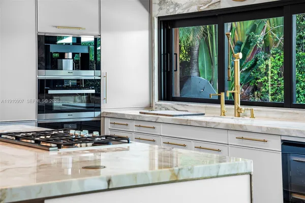 a kitchen with a stove and a white cabinet