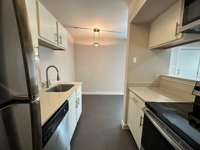 a kitchen with a sink and a stove top oven