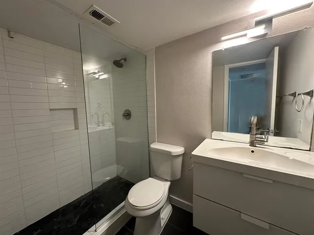 a bathroom with a sink toilet and shower