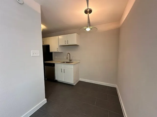 a kitchen with a sink cabinets and window
