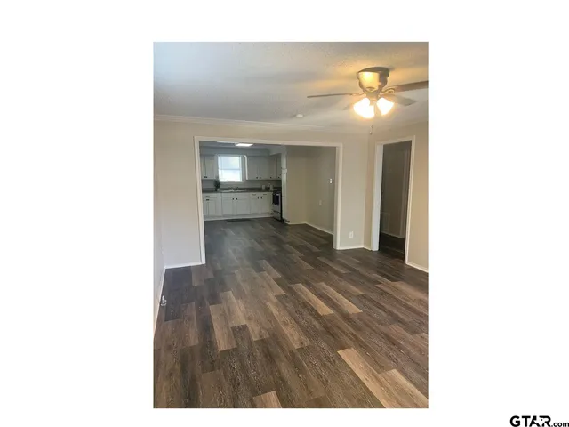 a view of a room with wooden floor