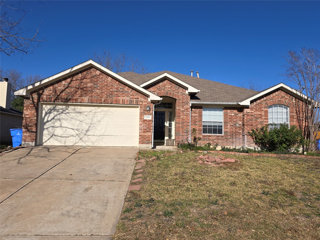 a view of a house with a yard and garage