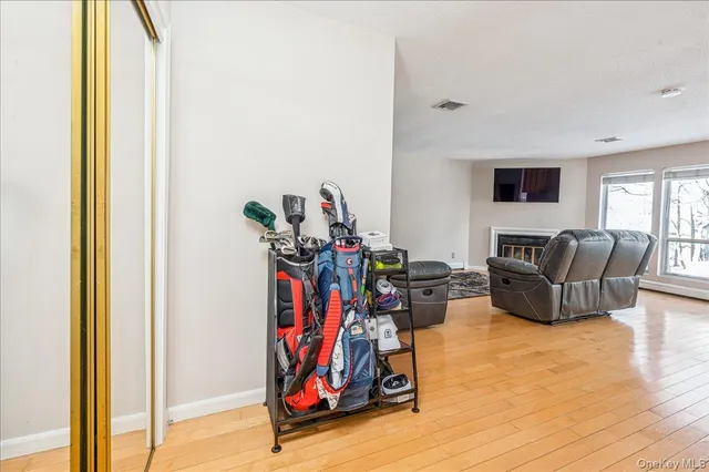 a living room with furniture a flat screen tv and a window