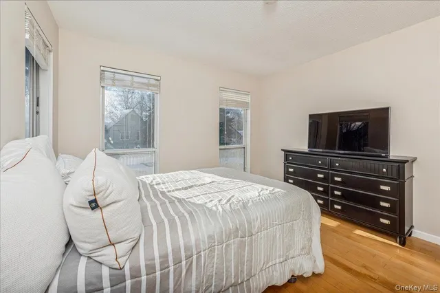 a bedroom with a bed and a television