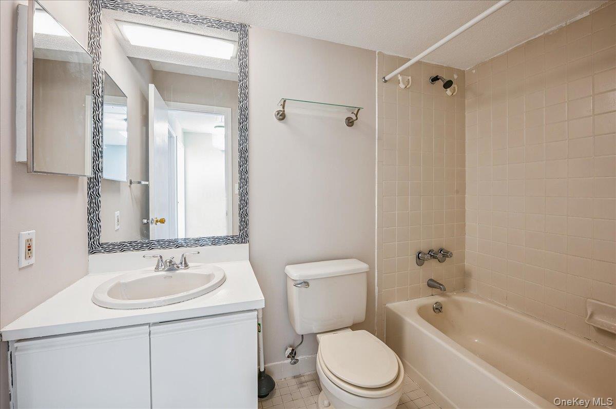 58 Villa Drive Peekskill, NY 10566 - Photo 14 of 21 Full Hall bath featuring bathing tub / shower combination, vanity, and a textured ceiling