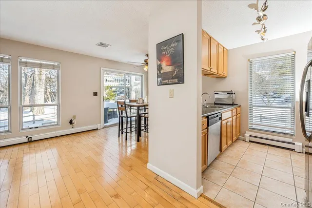 a view of a kitchen with furniture wooden floor and windows