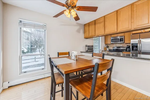 a view of a dining room with furniture window and wooden floor