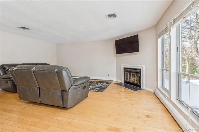a living room with furniture fireplace and flat screen tv