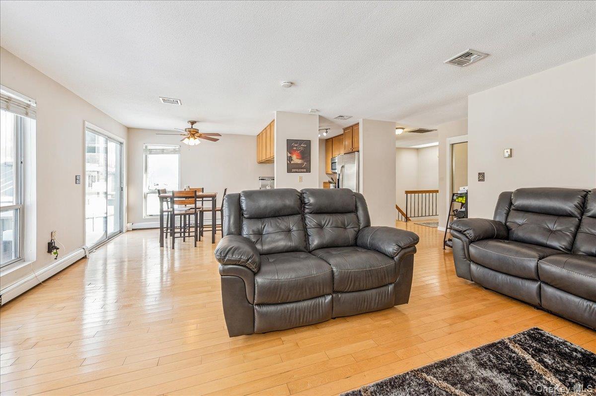 58 Villa Drive Peekskill, NY 10566 - Photo 9 of 21 Living room with light wood-type flooring, ceiling fan, and a textured ceiling