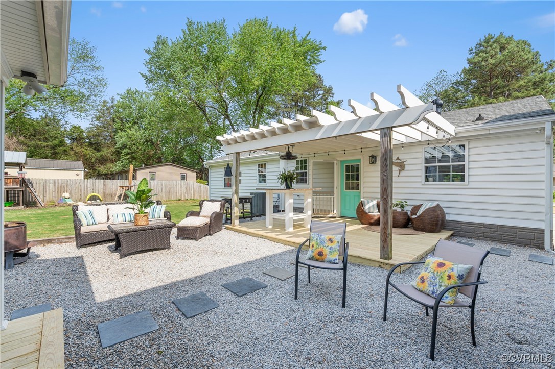 13923 White Oak Drive Lanexa, VA 23089 - Photo 12 of 46 a view of a patio with a dining table and chairs with wooden fence