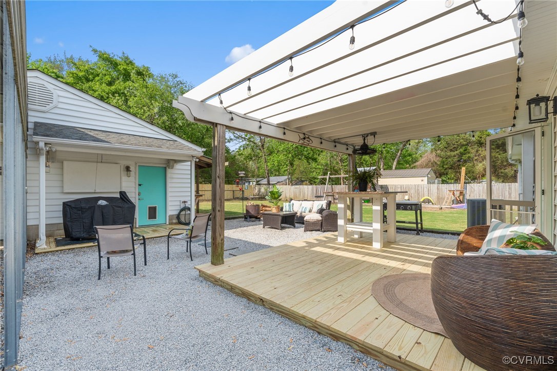 13923 White Oak Drive Lanexa, VA 23089 - Photo 3 of 46 a view of a patio with table and chairs potted plants and floor to ceiling window