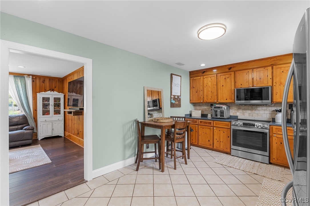 13923 White Oak Drive Lanexa, VA 23089 - Photo 38 of 46 a kitchen with stainless steel appliances granite countertop a stove top oven a sink dishwasher and a refrigerator with wooden floor