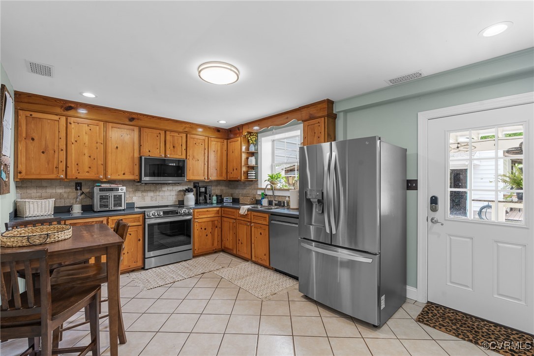 13923 White Oak Drive Lanexa, VA 23089 - Photo 39 of 46 a kitchen with stainless steel appliances granite countertop a refrigerator stove top oven and sink