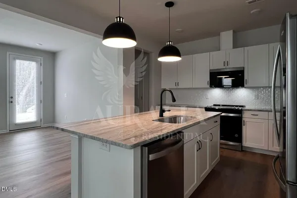 a kitchen with a sink a counter top space and cabinets