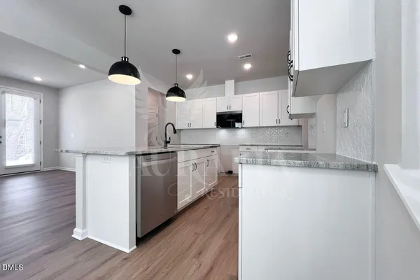 a kitchen with stove a sink and refrigerator