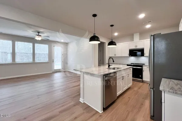 a kitchen with stainless steel appliances a refrigerator sink and cabinets