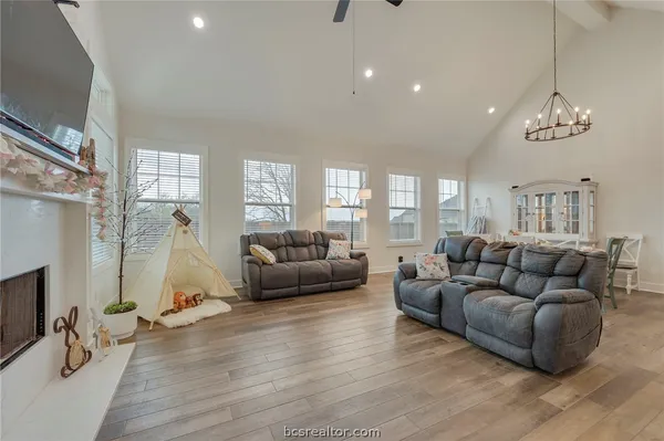 a living room with furniture a fireplace and a flat screen tv