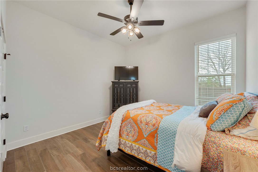 4357 Fox River Lane Bryan, TX 77802 - Photo 13 of 24 a bedroom with a bed and a tv