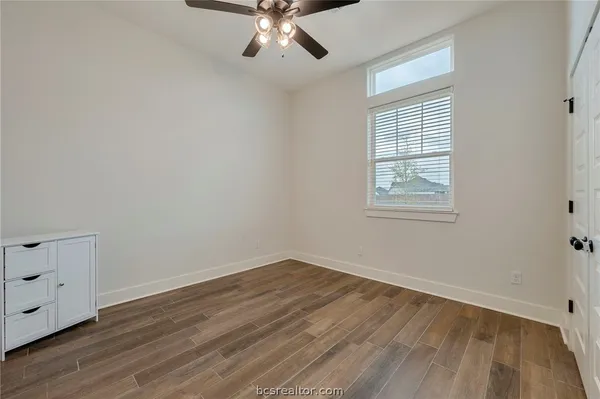 a bedroom with a bed and a tv