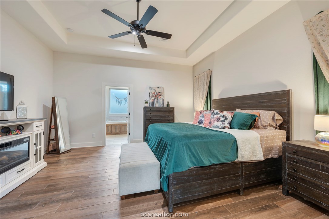 4357 Fox River Lane Bryan, TX 77802 - Photo 16 of 24 a bedroom with a bed and a flat tv screen
