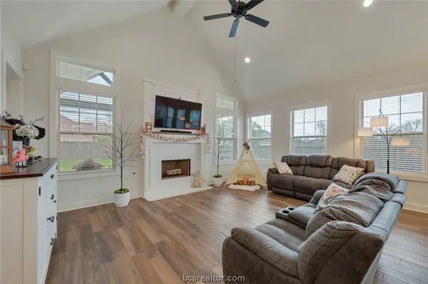 a living room with fireplace furniture and a flat screen tv