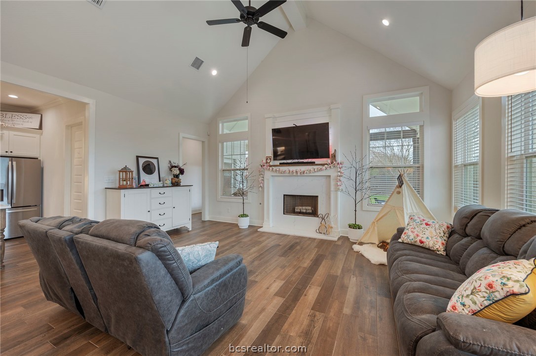 4357 Fox River Lane Bryan, TX 77802 - Photo 9 of 24 a living room with furniture a fireplace and a flat screen tv