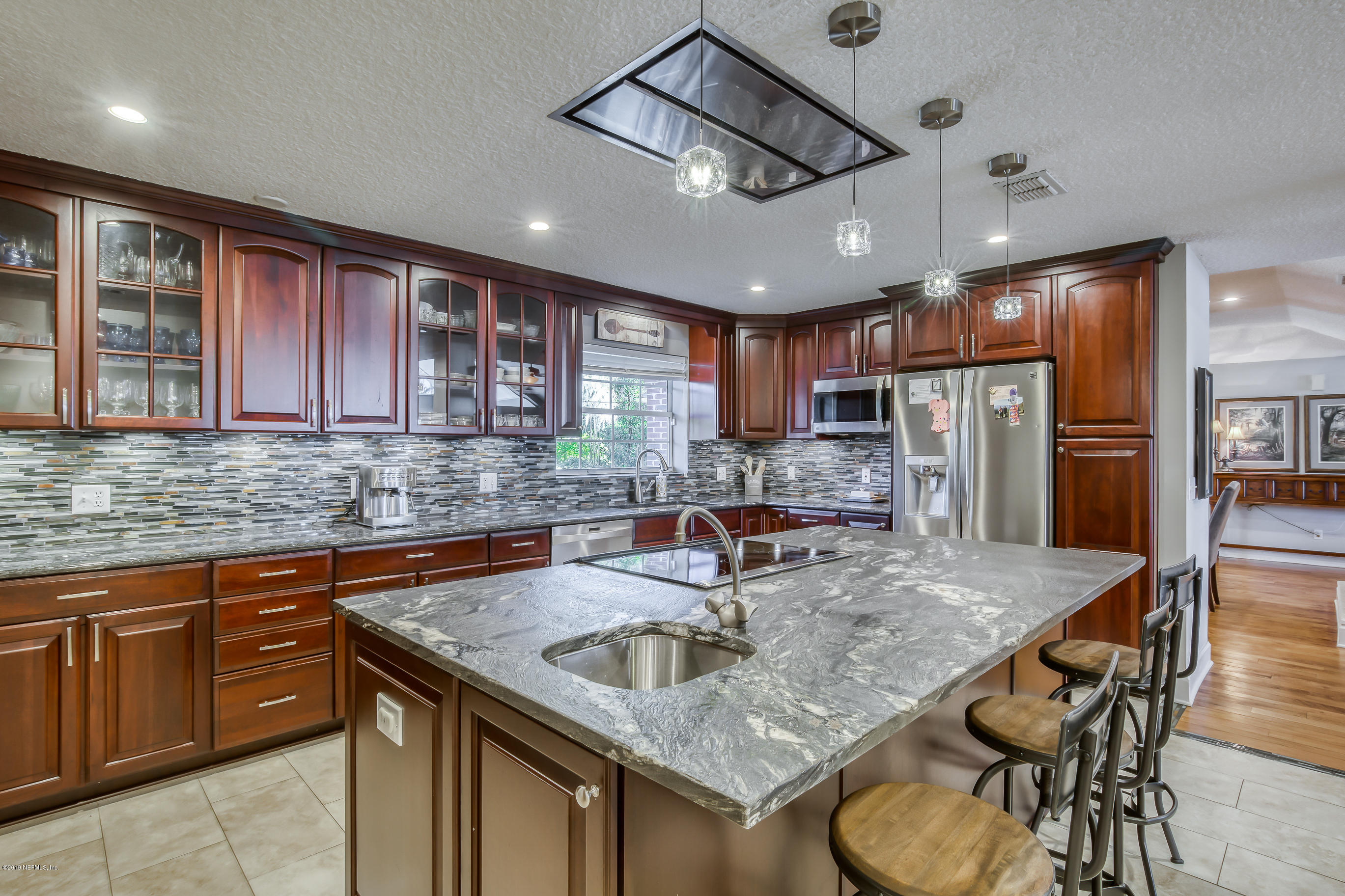 1105 Popolee Road St. Johns, FL 32259 - Photo 22 of 81 a kitchen with stainless steel appliances granite countertop a sink refrigerator and cabinets