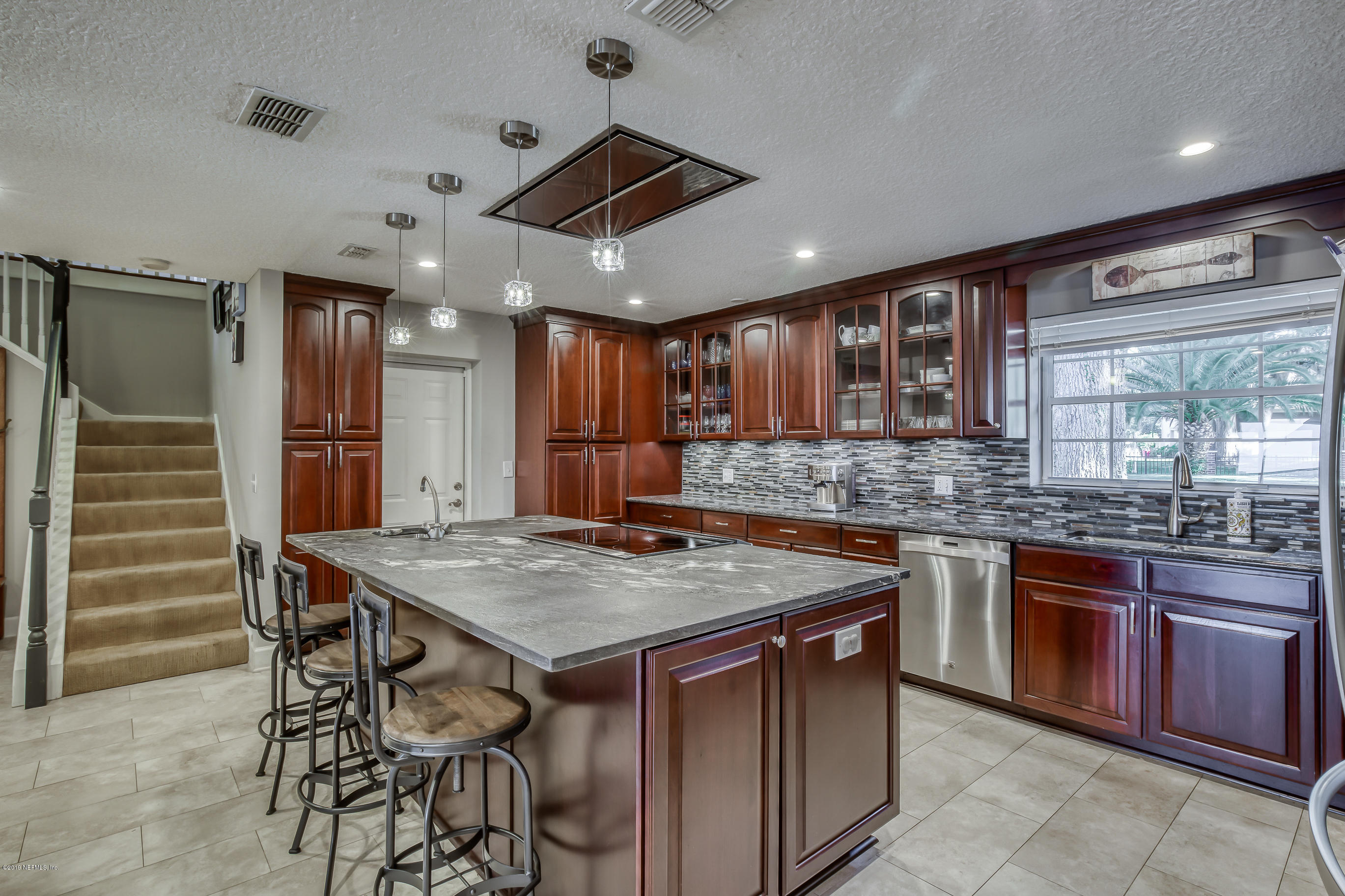 1105 Popolee Road St. Johns, FL 32259 - Photo 23 of 81 a kitchen with stainless steel appliances granite countertop wooden cabinets a refrigerator and a sink
