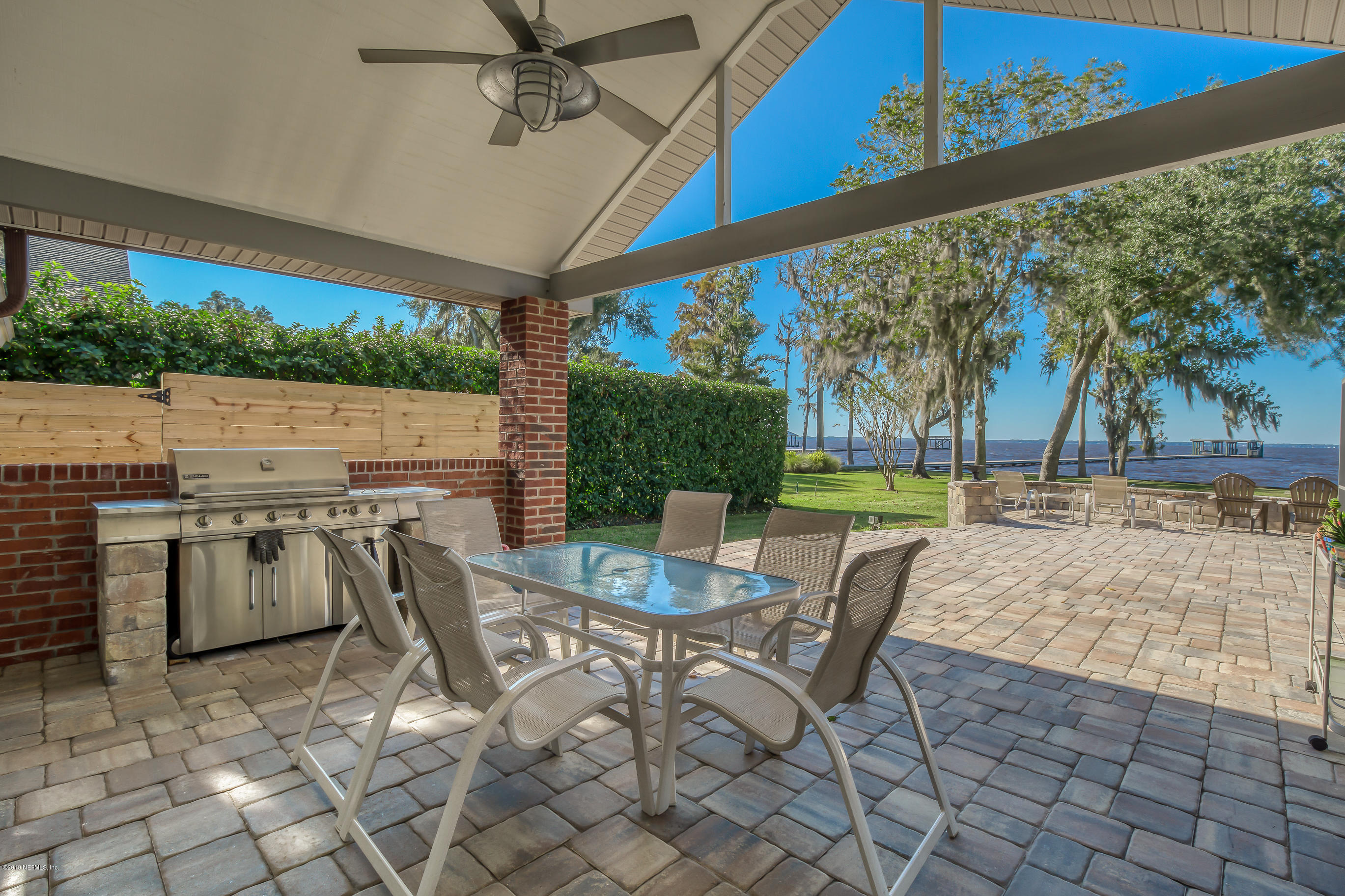 1105 Popolee Road St. Johns, FL 32259 - Photo 53 of 81 a view of a patio with a table chairs and a backyard