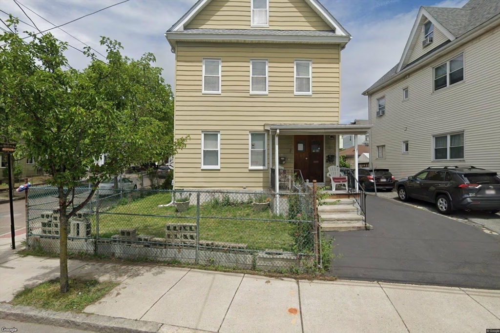 66 Cottage Street, Unit 1 Everett, MA 02149 - Photo 1 of 9 a view of a house with a yard