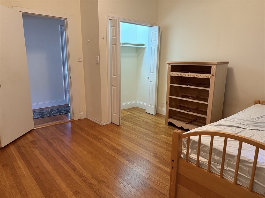66 Cottage Street, Unit 1 Everett, MA 02149 - Photo 3 of 9 a view of room with wooden floor and closet