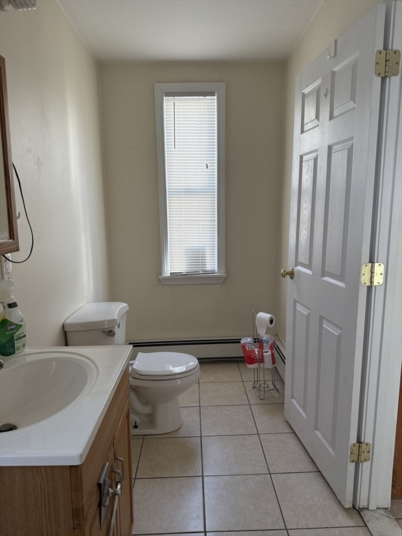 66 Cottage Street, Unit 1 Everett, MA 02149 - Photo 4 of 9 a bathroom with a sink toilet and a mirror